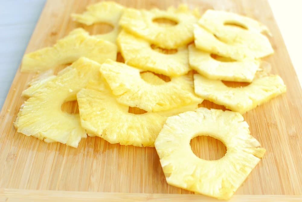 sliced pineapple on a cutting board