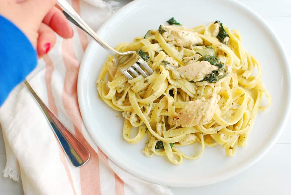 a woman twirling pasta with a fork