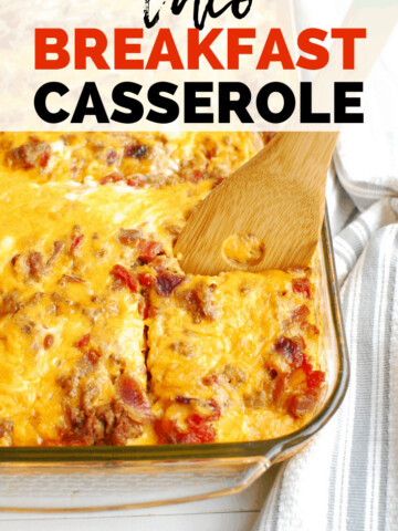 a taco breakfast casserole in a large dish with a wooden spoon scooping a piece out