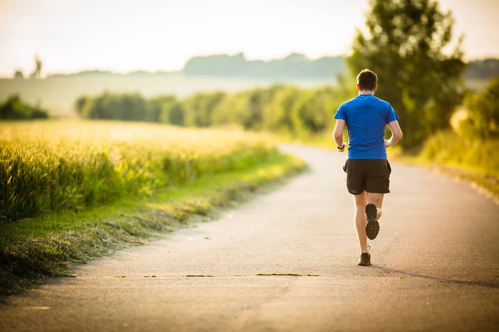 a man running outside on a sunny day