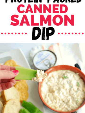 a woman's hand dipping celery into canned salmon dip