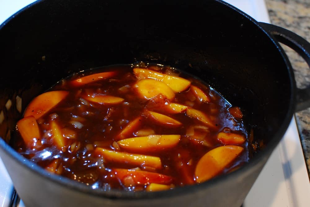 the sauce for peach whiskey chicken in a dutch oven
