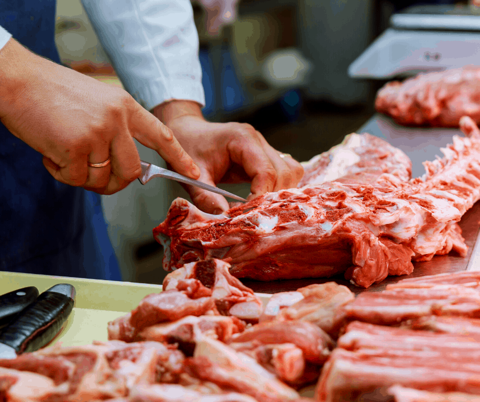 a butcher cutting steaks