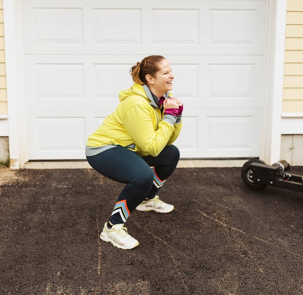 a woman doing a squat exercise outside