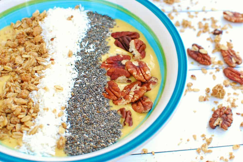 a close up of the chia seeds and pecans on top of a smoothie bowl