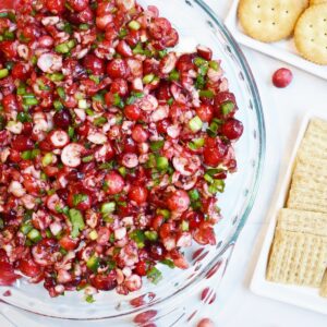 Cranberry dip next to assorted crackers.