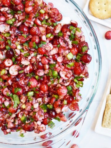 Cranberry dip next to assorted crackers.