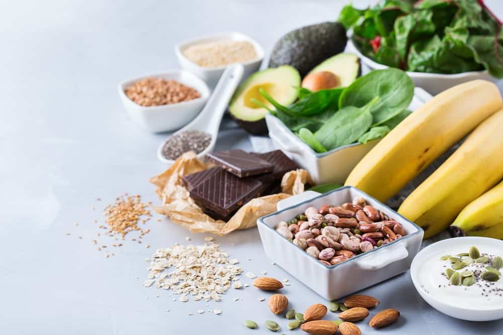 food sources of magnesium for runners, like dark chocolate, nuts, bananas, spinach, avocado, and seeds