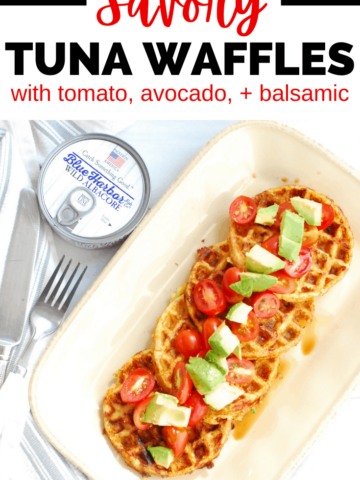 four tuna waffles on a plate topped with tomato and avocado