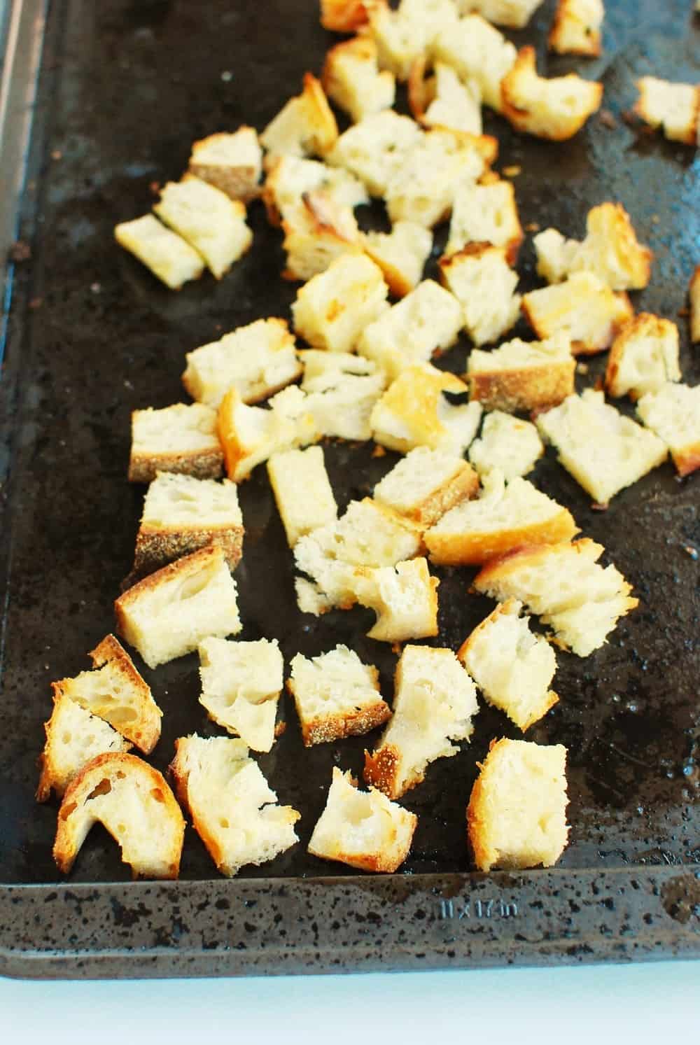 a pan with toasted chunks of bread