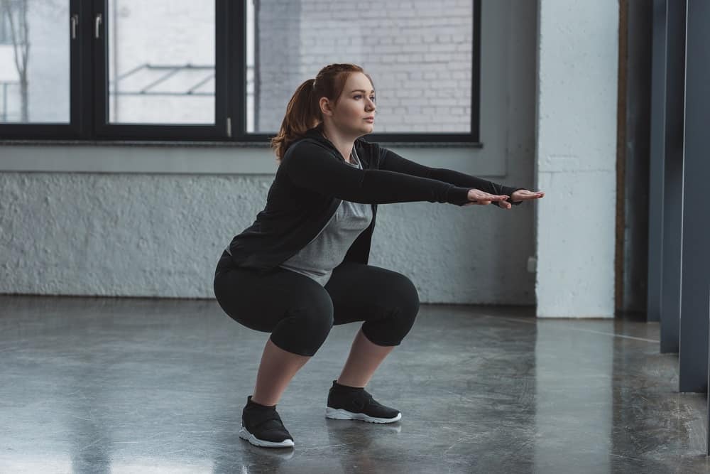 a woman doing a squat