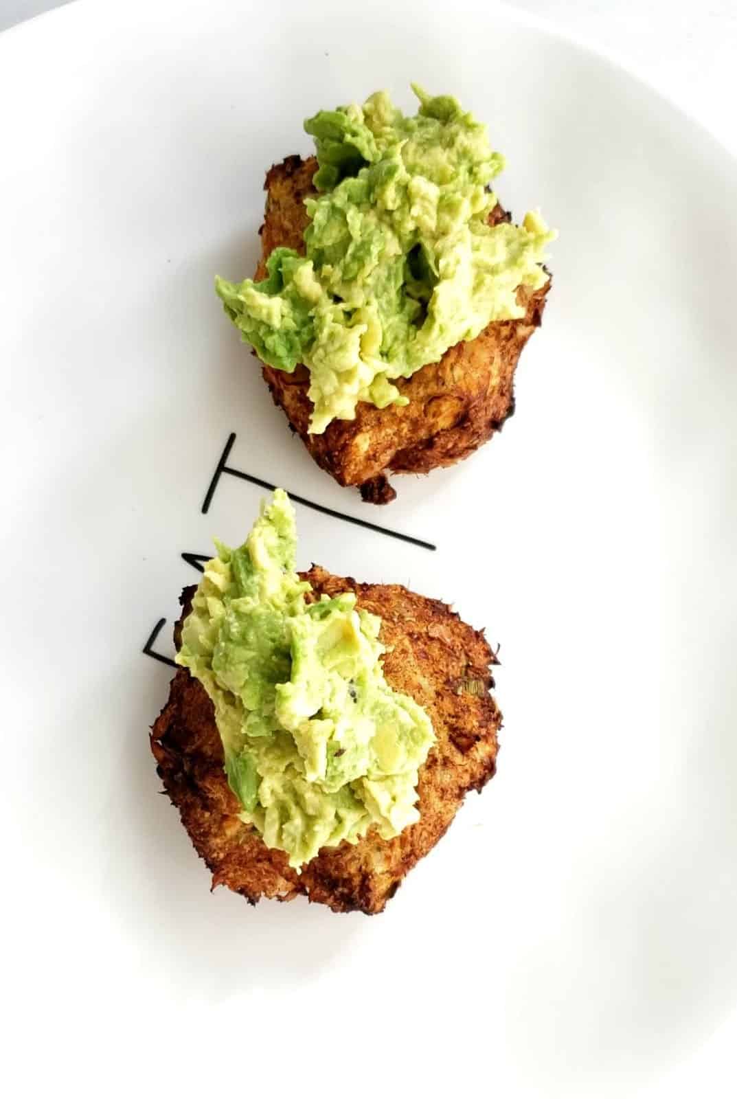 two air fryer salmon patties topped with avocado