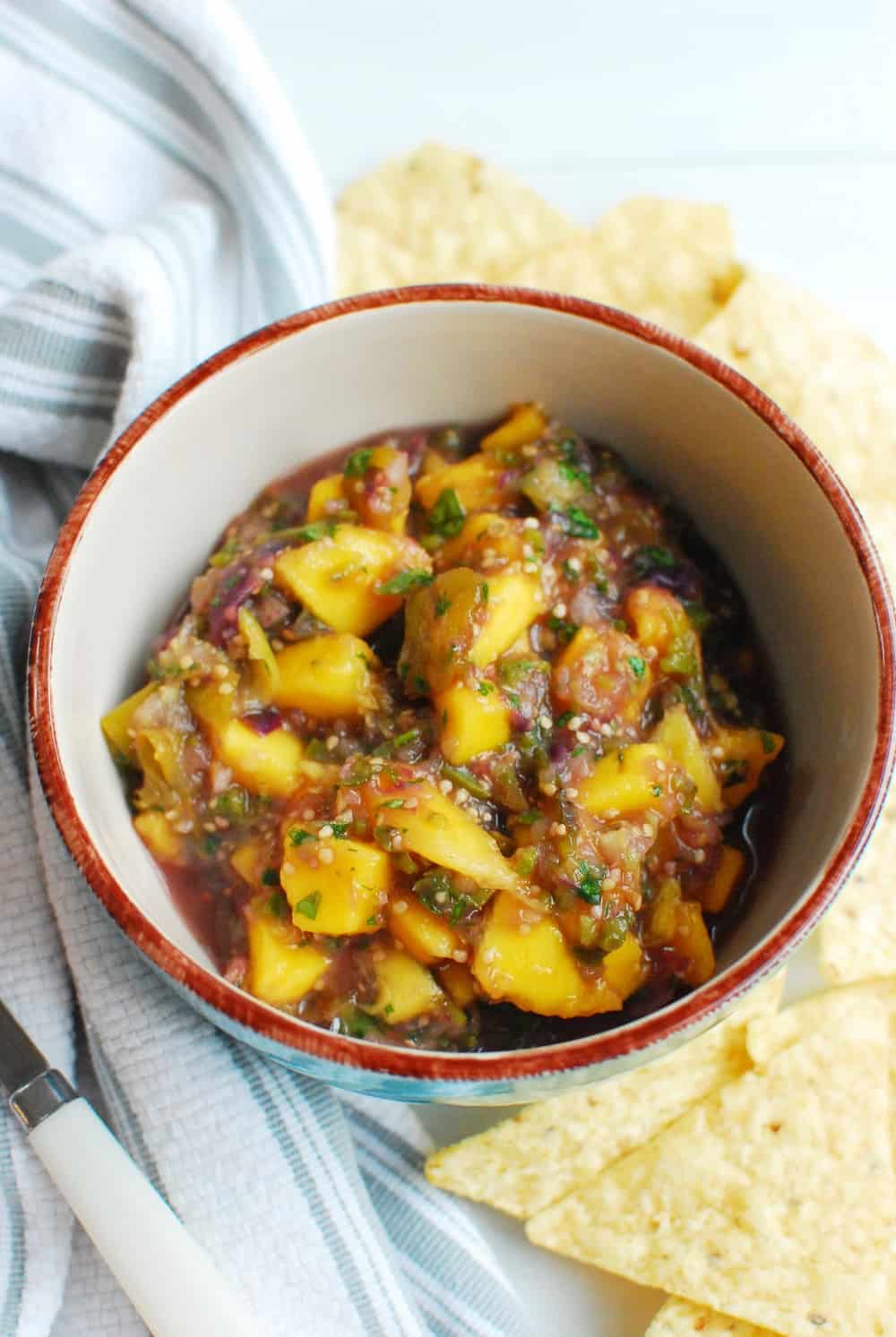 Mango Tomatillo Salsa Snacking in Sneakers