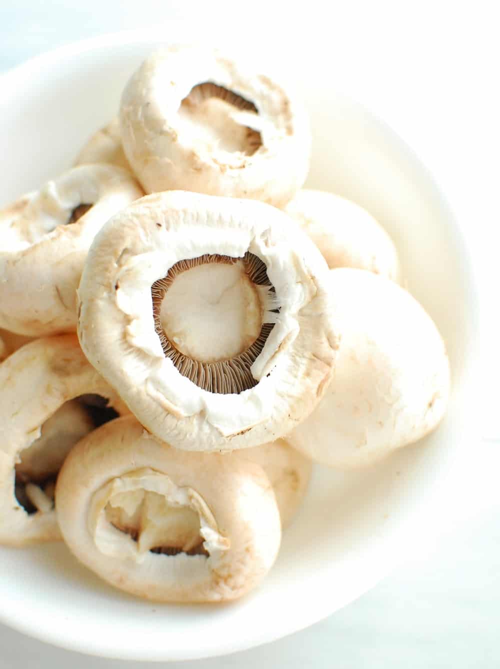 a bowl of de-stemmed mushrooms