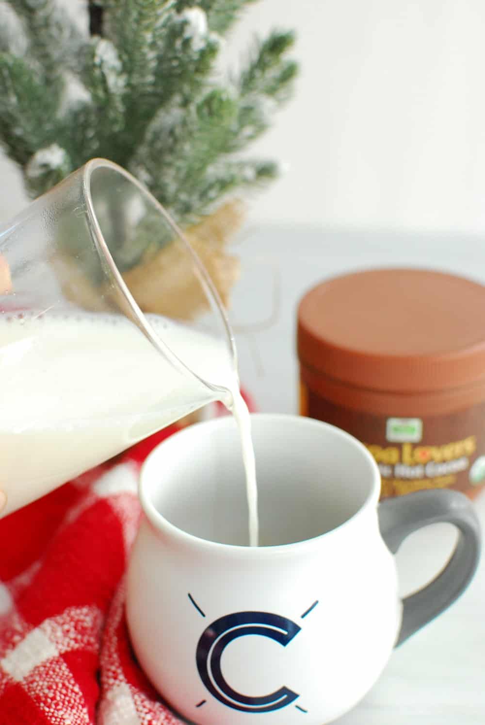 pouring hot milk into a mug