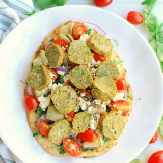 a Mediterranean flatbread topped with veggies and turkey meatballs