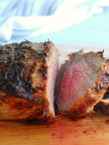 an air fryer beef roast sliced on a cutting board