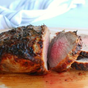 an air fryer beef roast sliced on a cutting board