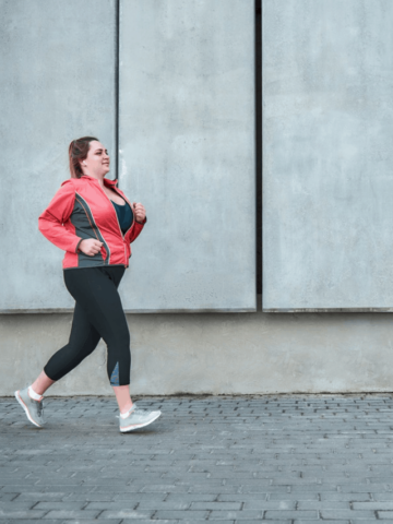 a woman just starting to jog outside
