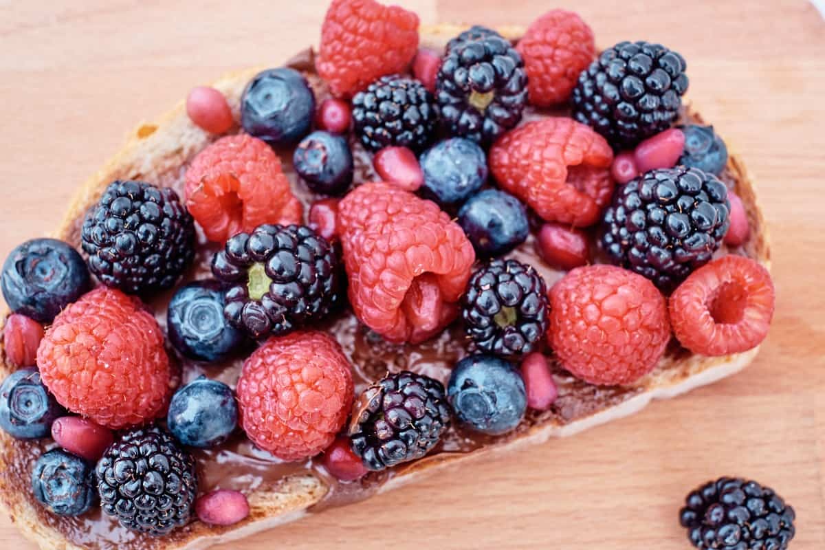 a slice of toast with chocolate nut butter and berries