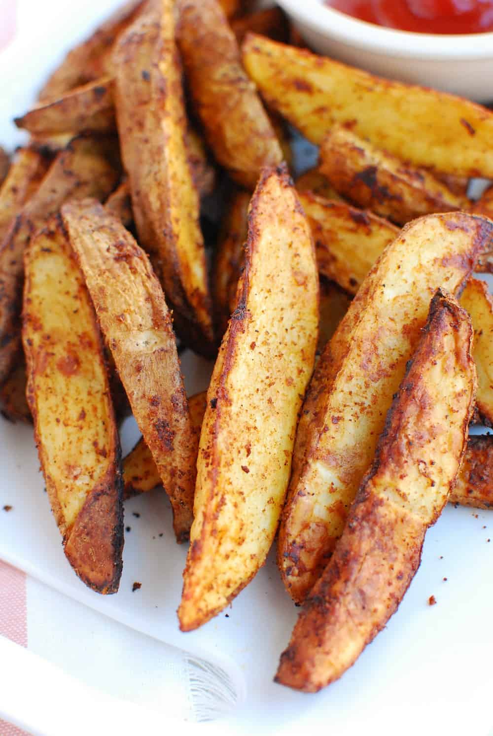A close up of several air fryer potato wedges.
