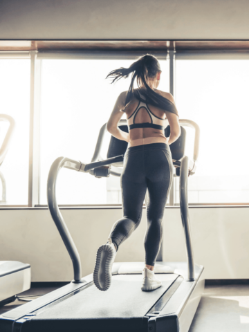 a woman running on a treadmill