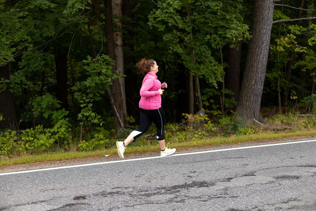 a woman running outside on the street