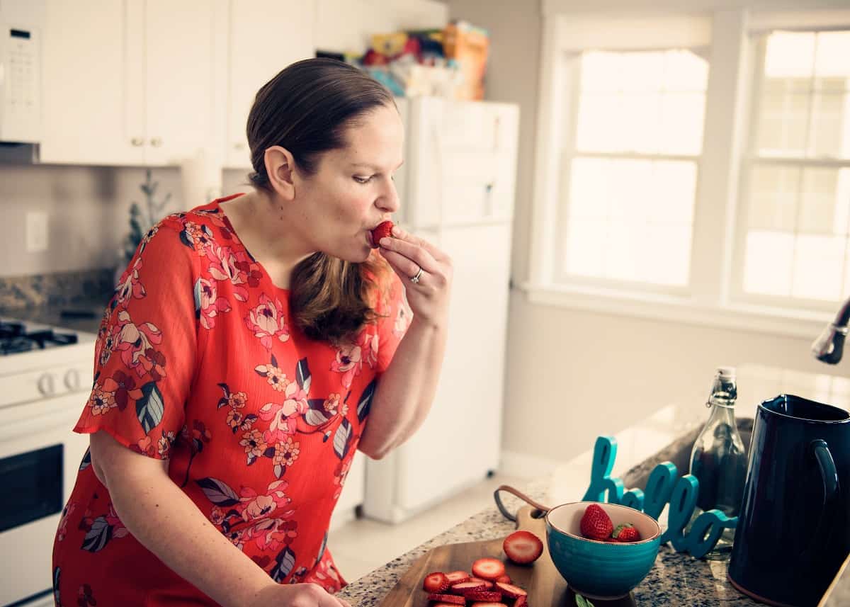 a woman eating strawberries