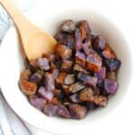 Herb roasted purple potatoes in a large serving bowl.