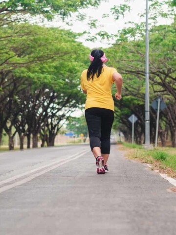 A beginner runner on the road learning how to run a mile without stopping.