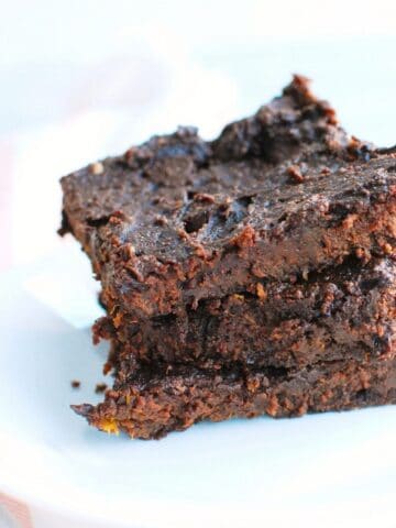 Three healthy butternut squash brownies on a plate.