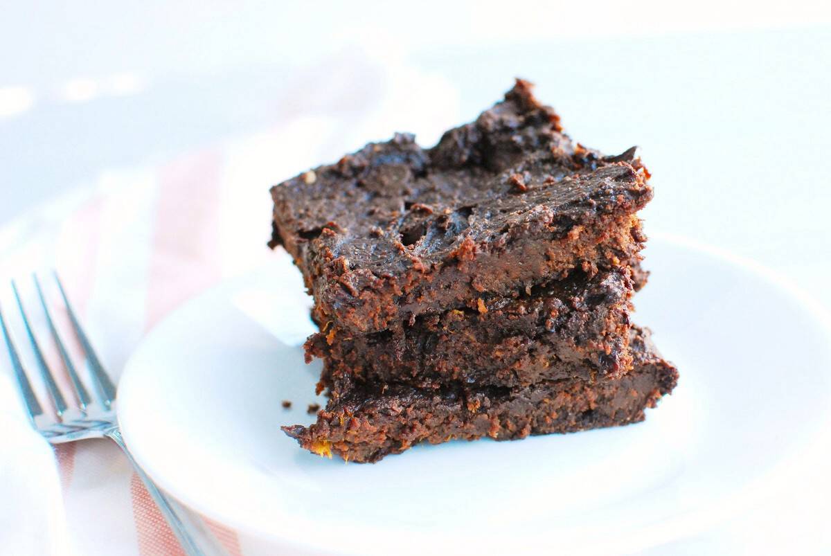 Three healthy butternut squash brownies on a plate.