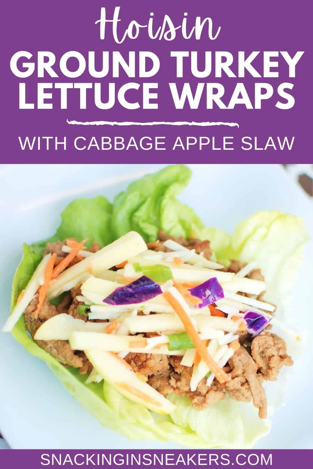 A hoisin turkey lettuce wrap topped with cabbage apple slaw, on a white plate.