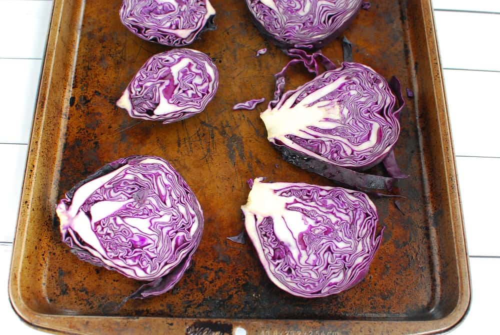 A baking sheet with cabbage rounds prior to cooking.