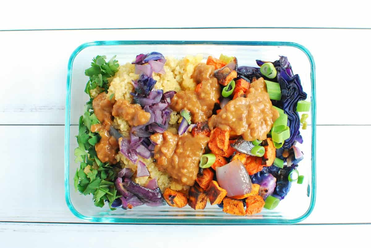 A meal prep container filled with the ingredients for a vegan power bowl.