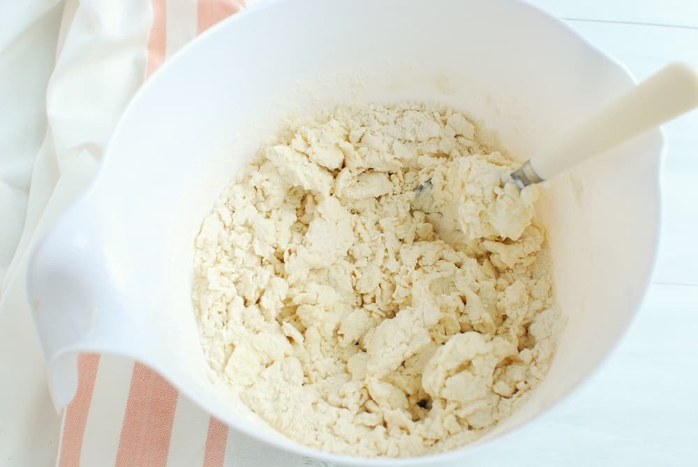 Ingredients for greek yogurt pizza dough in a bowl after initial mixing.