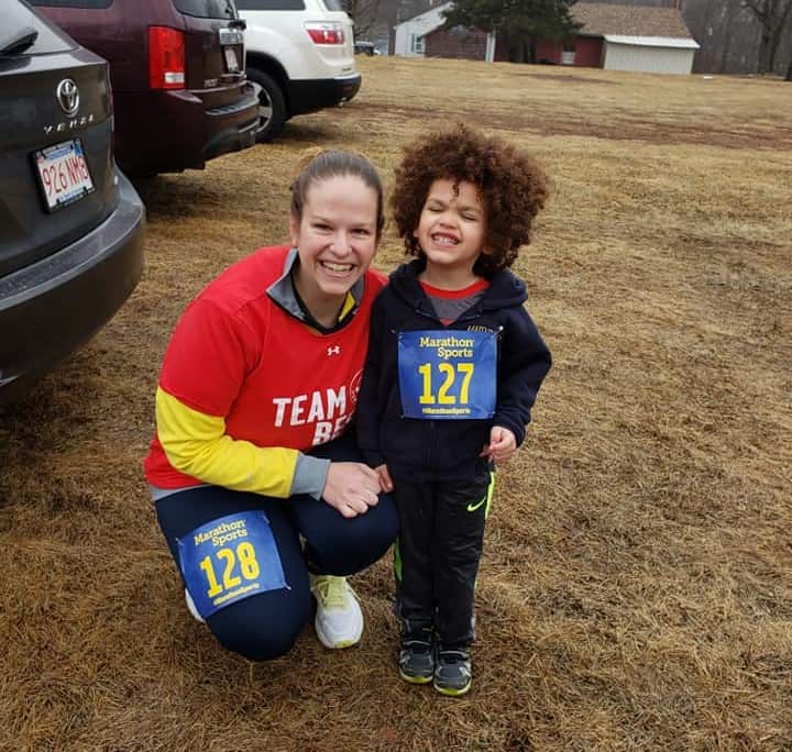 A child and his mom getting ready to run a 5K.