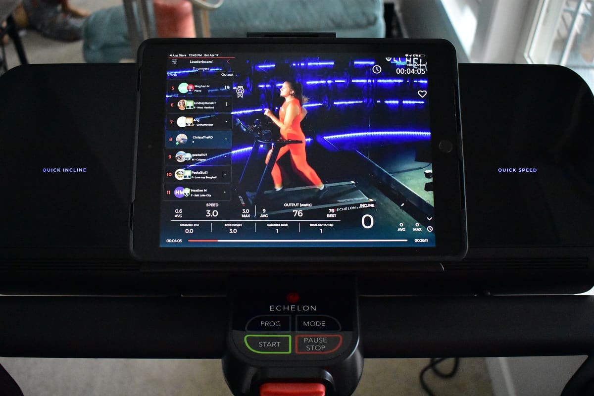 A tablet with a live running fitness class playing.