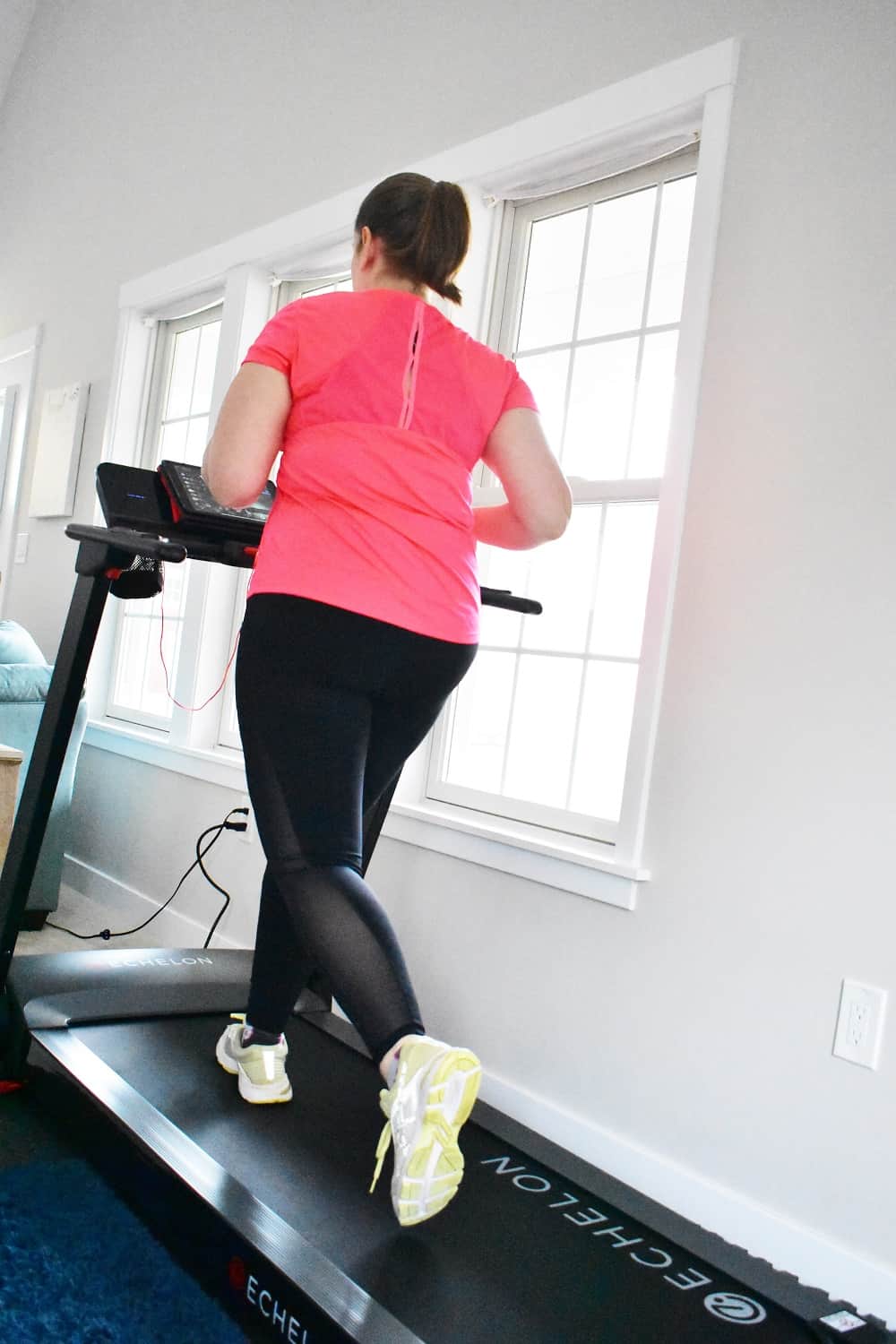 A woman running on the Echelon Stride treadmill.