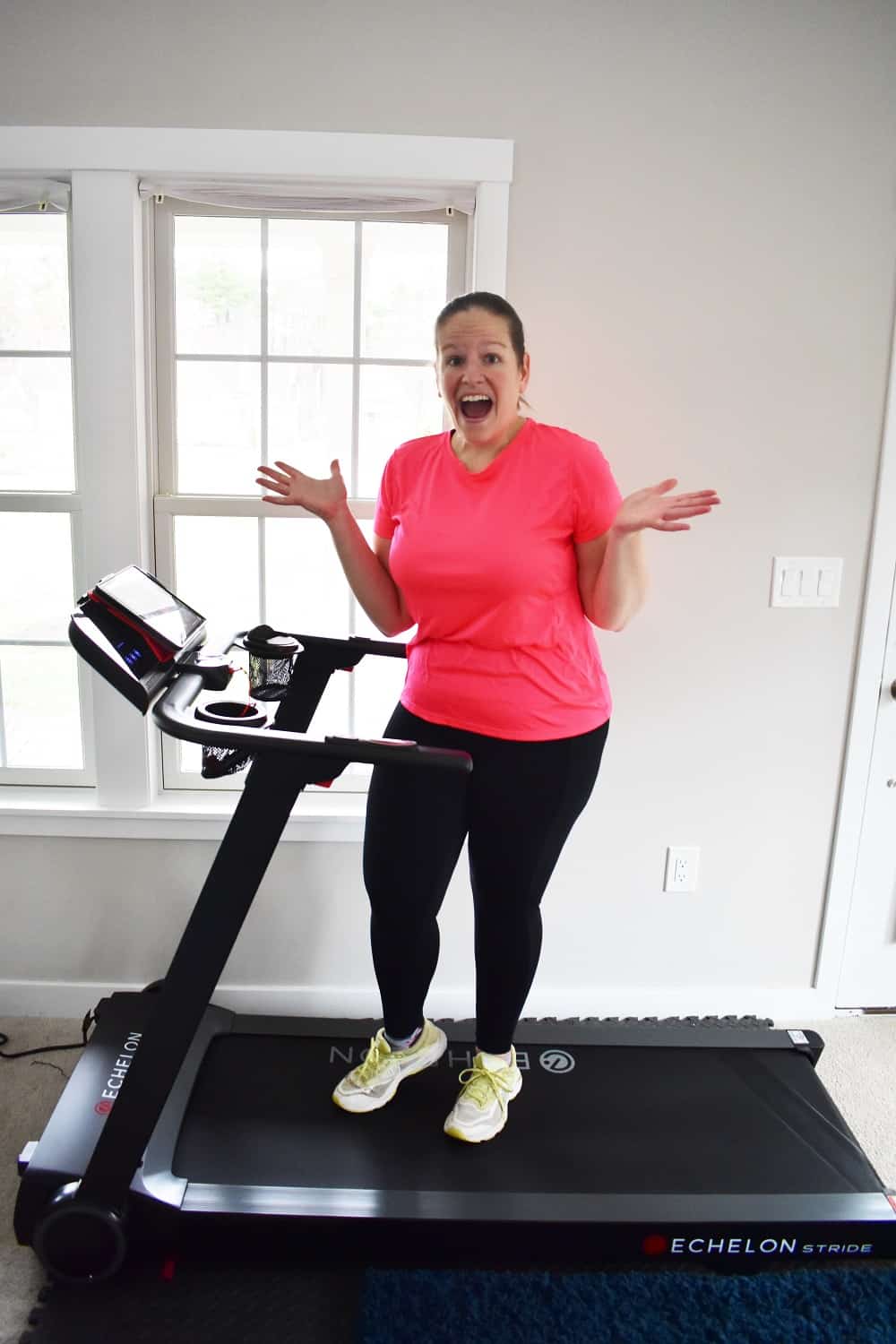 A woman excited to have an Echelon treadmill.