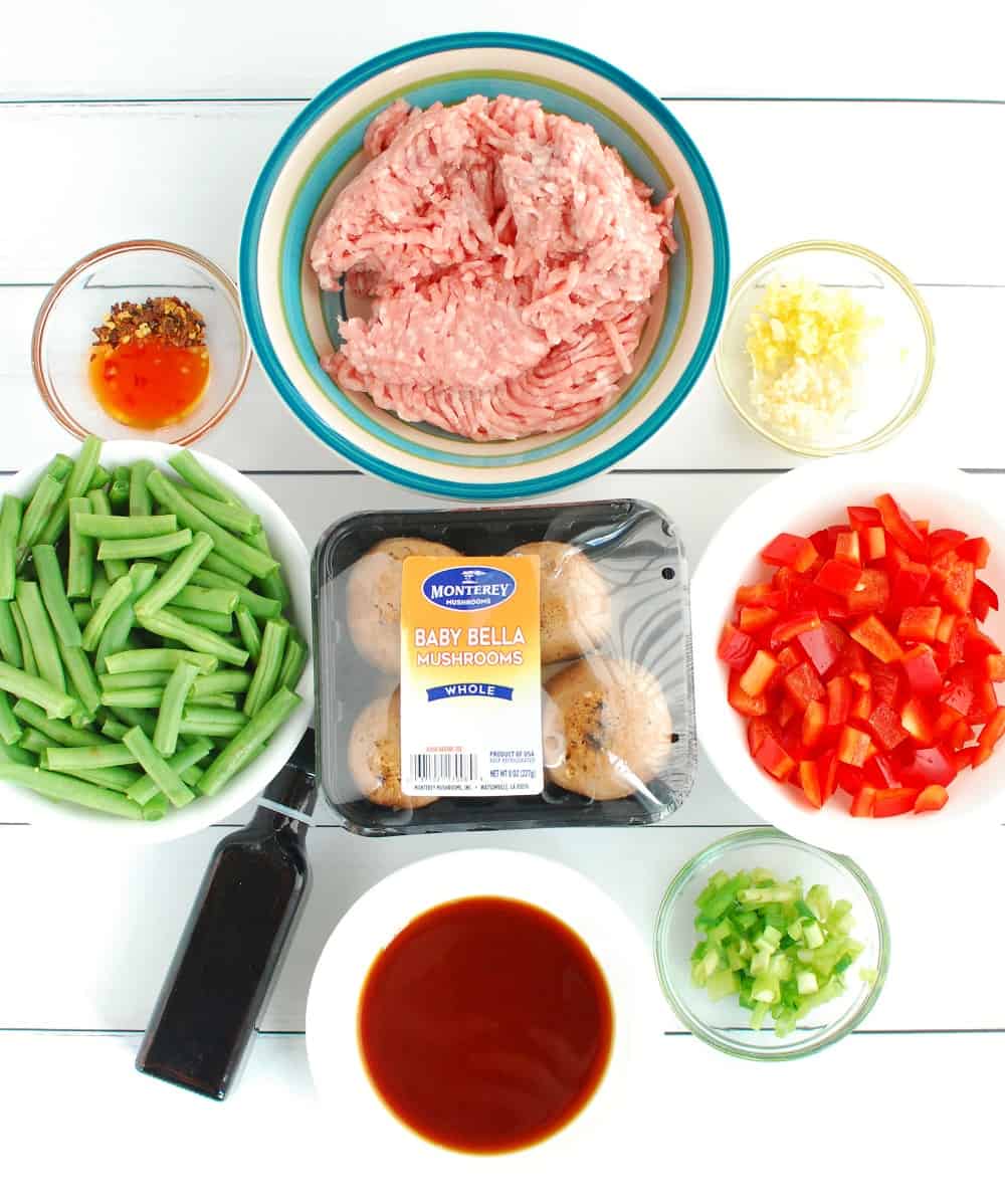 All of the ingredients to make the stir fry on a white backdrop.