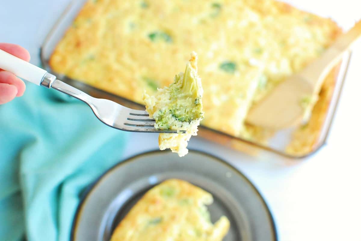 A fork with a bite of high protein breakfast casserole on it.