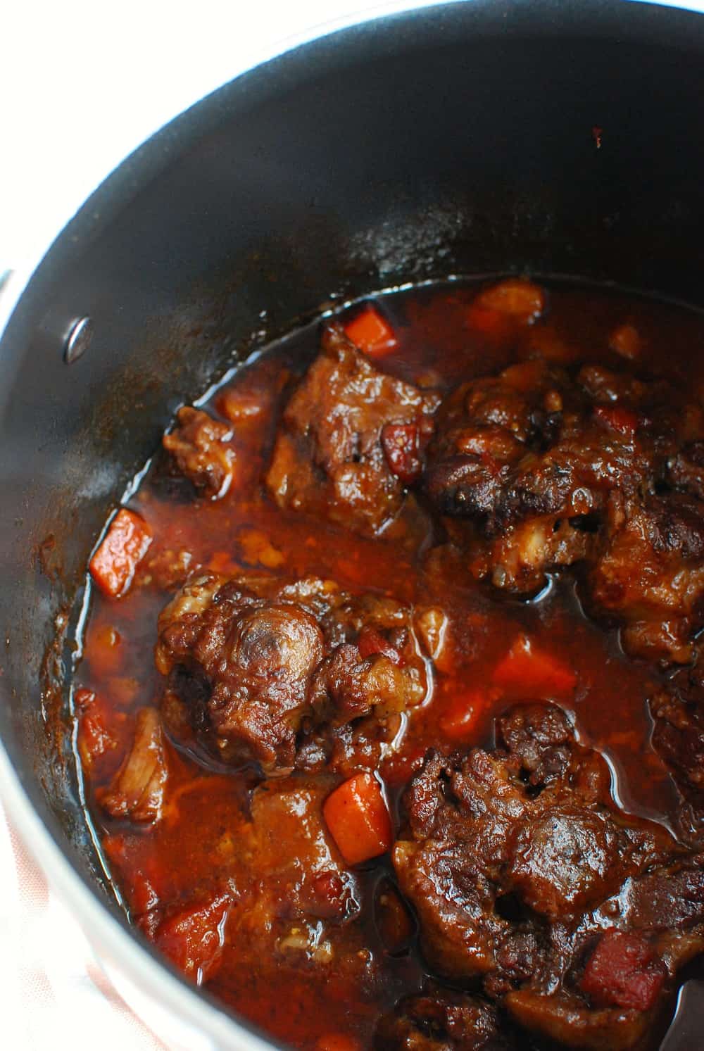 Braised oxtail in a pot at the end of cooking.