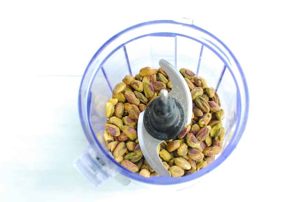 Shelled pistachios in a small food processor.