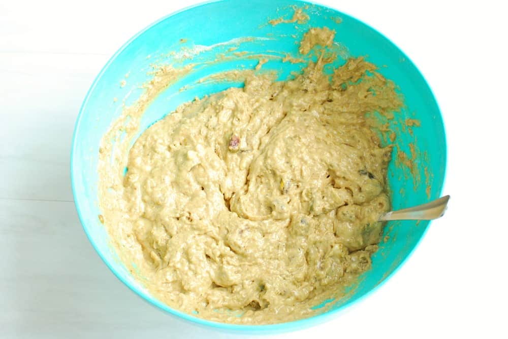 Banana bread batter in a blue bowl.