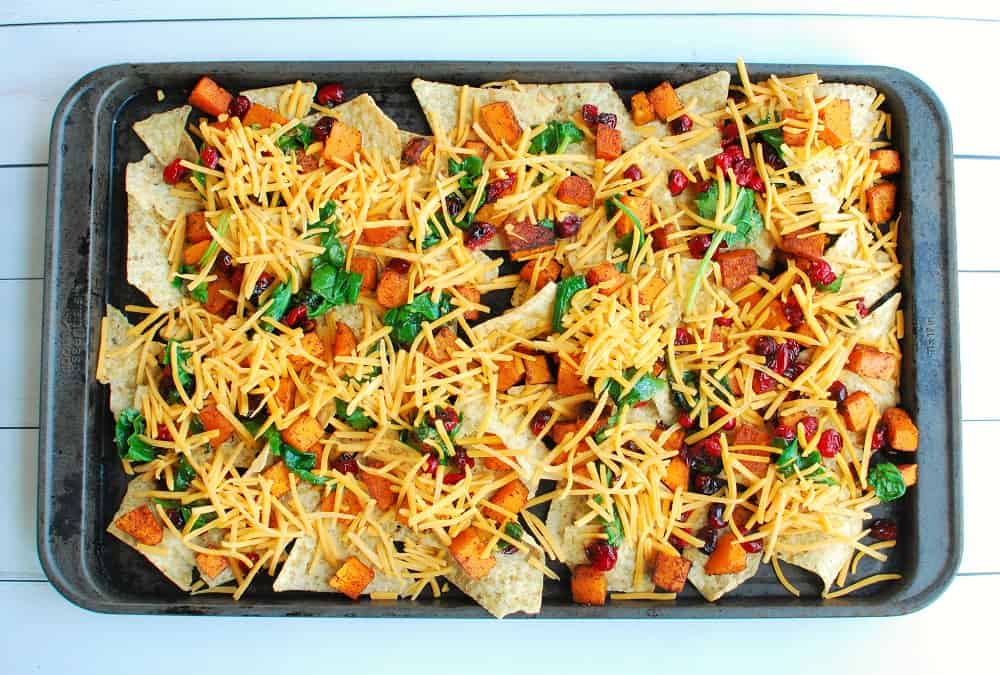 Sheet pan nachos before cooking in the oven.