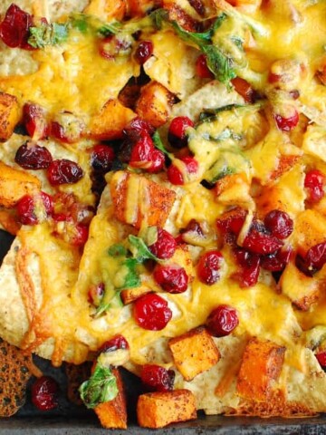 A sheet pan with cooked butternut squash nachos.