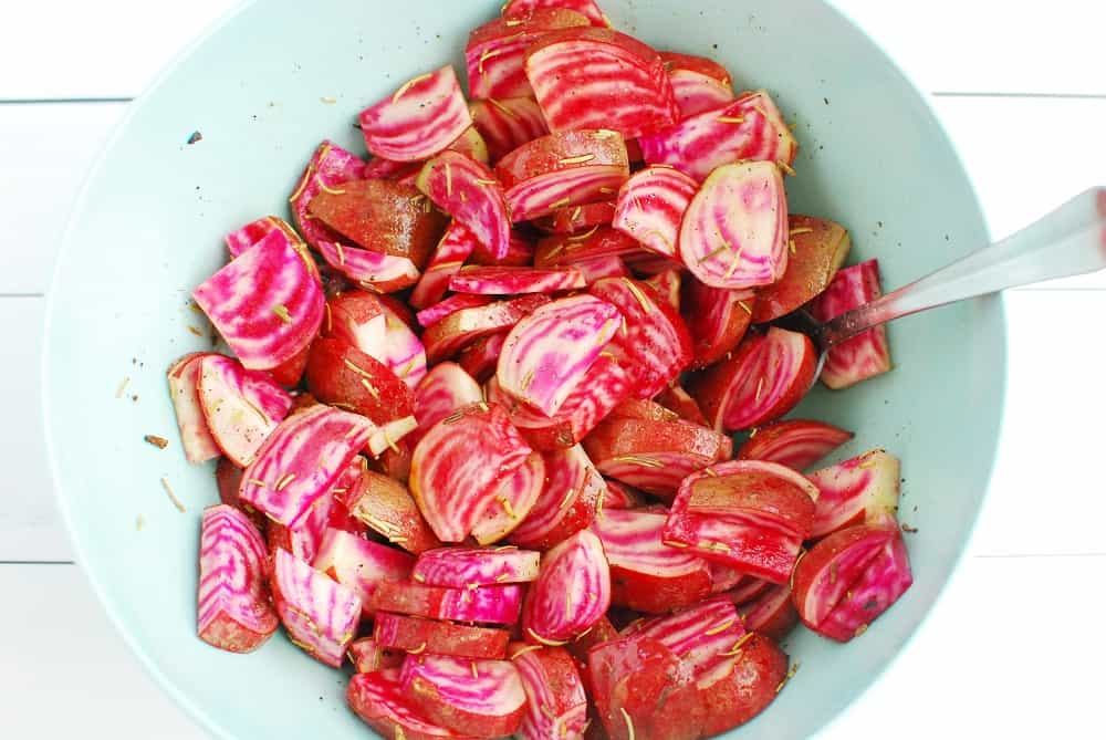 Chopped beets that have been tossed with oil, rosemary, salt, and pepper.