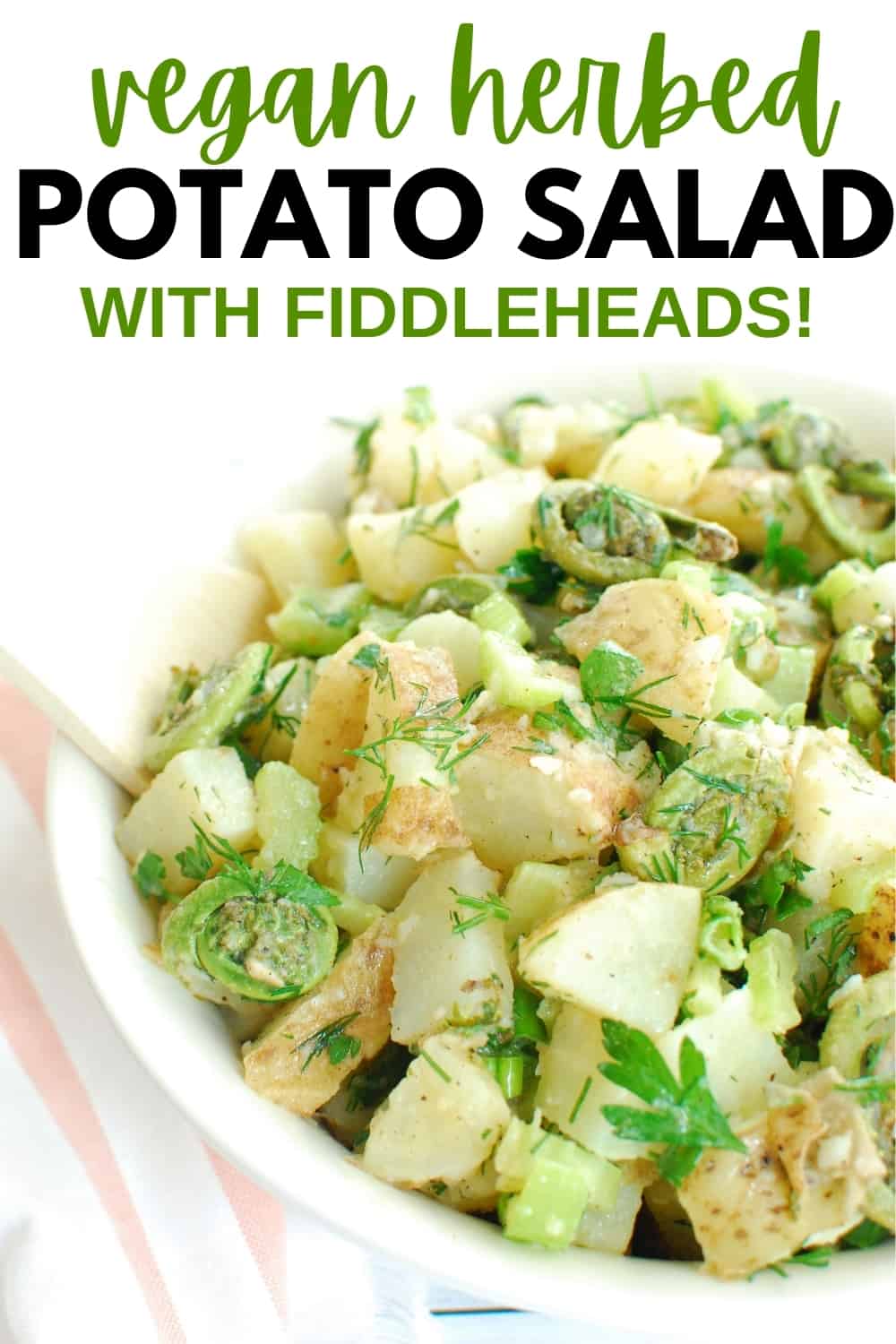 A bowl of healthy herbed potato salad with a wooden spoon, and a text overlay for Pinterest.