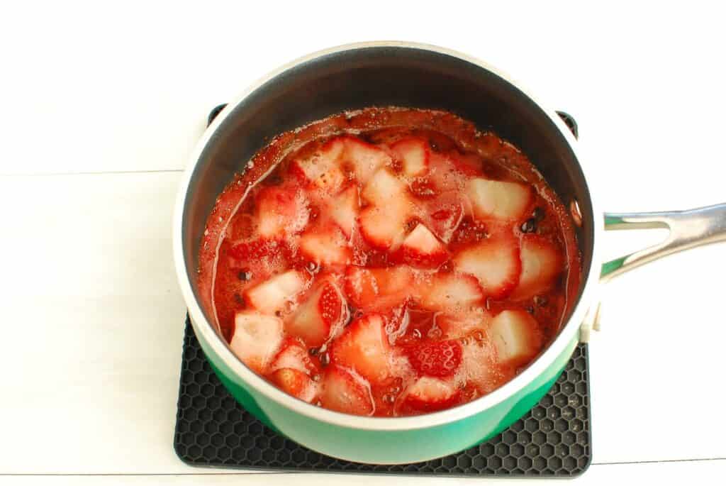 Cooked strawberries in a pot.